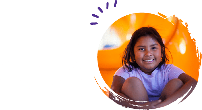 Slightly overweight child smiling on a playground
